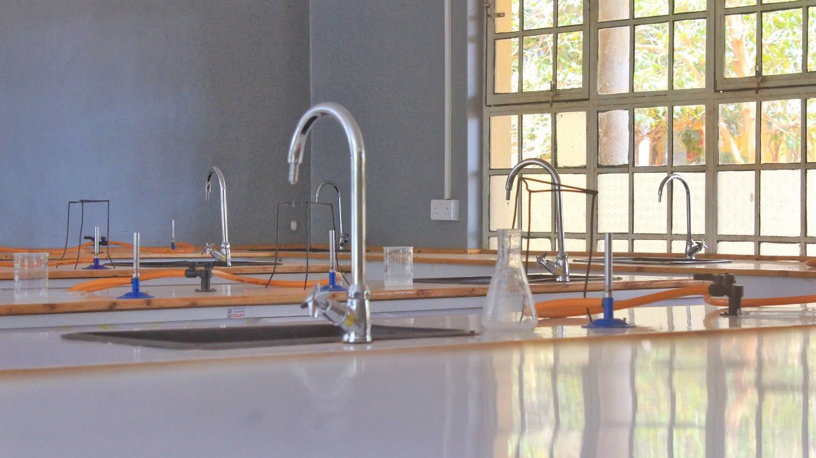 A laboratory sink with a tap and glassware