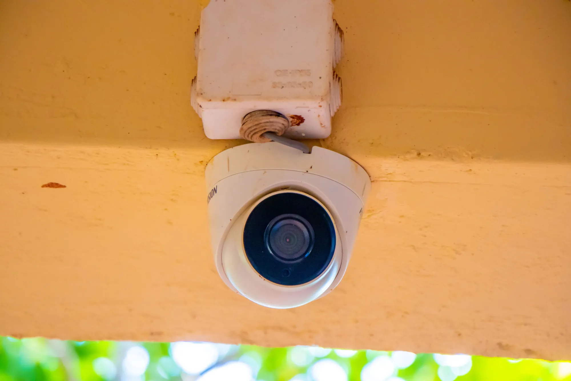 A security camera mounted under the school roof