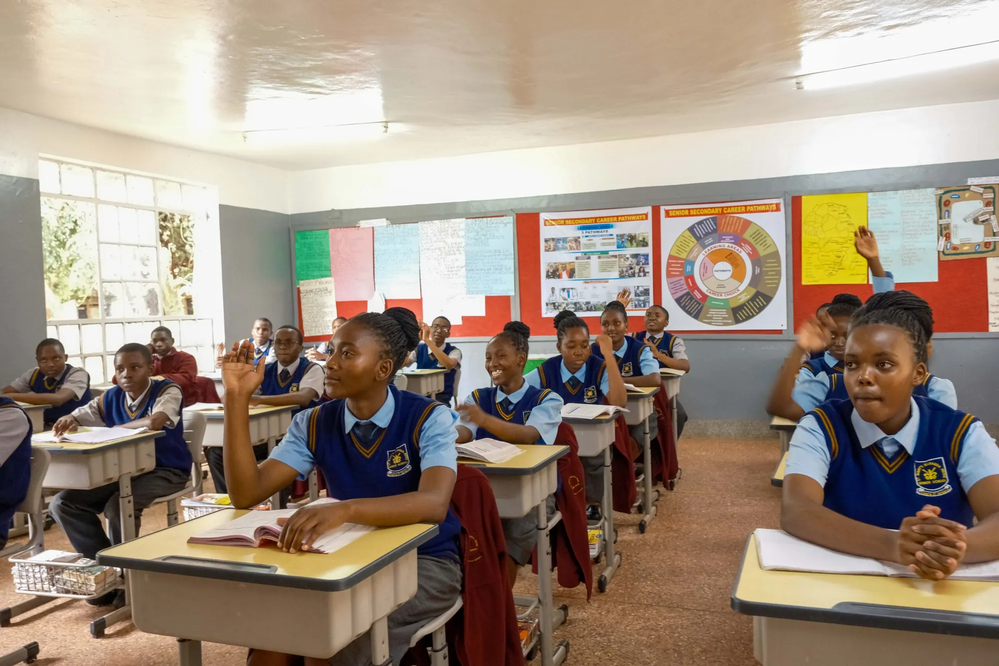Senior students listening in a bright classroom