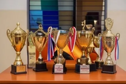 A display of gold sports trophies on a table